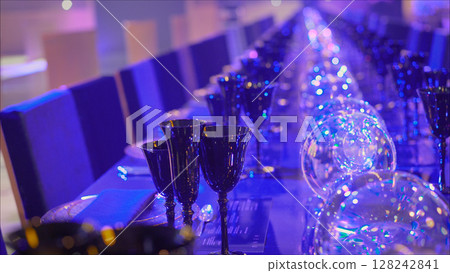 Table setting of wine glasses and dishes. Table service in the restaurant. Transparent clean glasses and wine glasses. 128242841