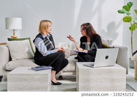 Mental therapy session, middle aged woman patient talking to professional psychologist Mental therapy session, middle aged woman patient talking to professional psychologist 128243252