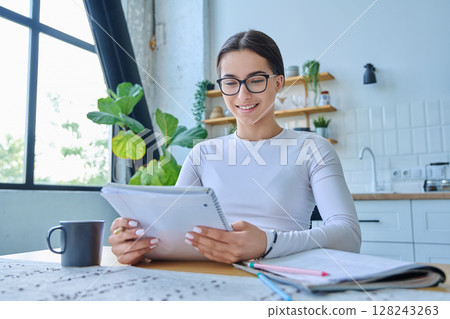 Webcam portrait female student teenager, sitting at home at the table 128243263