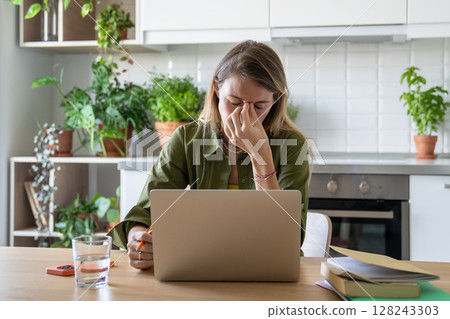 Upset woman rubbing eyes, overwhelmed at laptop, exhausted from work study, burnout and stress Upset woman rubbing eyes, overwhelmed at laptop, exhausted from work study, burnout and stress 128243303