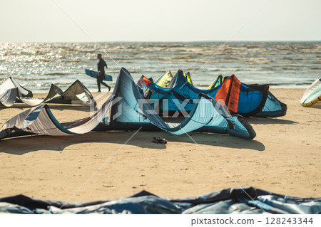 Kite surfing event at seaside beach with multicolored sails and boards. Summer activity in travel 128243344