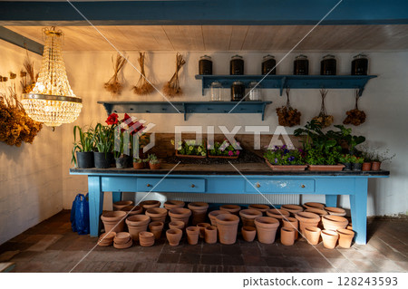 Small private flower shop offering plants soil and outdoor accessories for sale to gardening lover 128243593