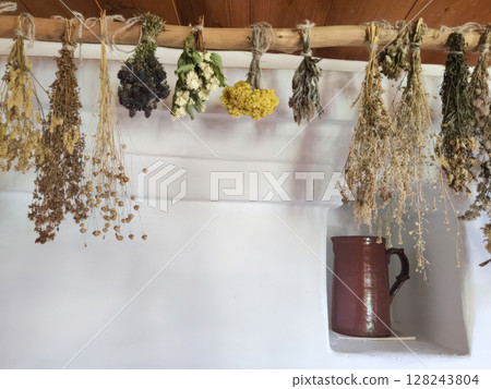 Traditional Russian hut with a stove and dried wild herbs. Horizontal photo of an old interior, 1820s, Mikhailovskoye village, Pushkin's nanny's house. Traditional Russian hut with a stove and dried wild herbs. Horizontal photo of an old interior, 1820s, Mikhailovskoye village, Pushkin's nanny's house. 128243804