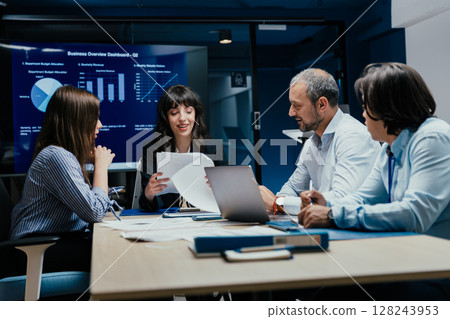 Business executives and assistants brainstorming investment risk evaluation in corporate boardroom Business executives and assistants brainstorming investment risk evaluation in corporate boardroom 128243953