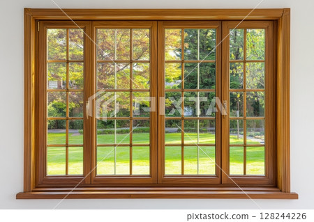 New wooden PVC window with brown metal frame installed at modern house, view of blurred green trees, blue sky. Advertising. Typical installation of insulated glazing windows with uPVC window frames. 128244226