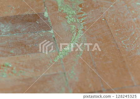 Ants Crawling on a Red Terracotta Tile Floor with Green Moss. Outdoor Pest Infestation Scenario, Texture, Natural Lighting 128245325