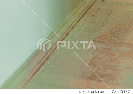 Close-Up View of Aged Wood Texture with Faded Red Lines and Earth-Toned Stains, Warm Lighting, Rough Surface Detail. Close-Up View of Aged Wood Texture with Faded Red Lines and Earth-Toned Stains, Warm Lighting, Rough Surface Detail. 128245327