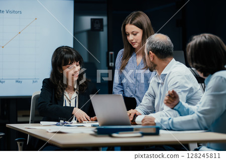 Young female colleague receives mentorship at a meeting in office 128245811