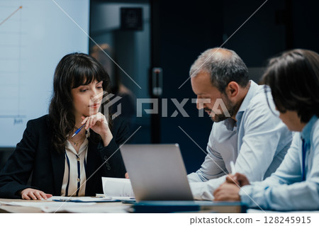 Colleagues listening attentively to opinion during business meeting in office Colleagues listening attentively to opinion during business meeting in office 128245915