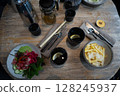An Elegant Dining Setup Featuring Fresh Ingredients and Exquisite Culinary Artistry 128245937