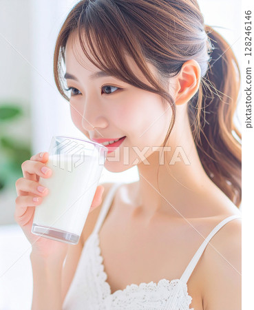 一位年輕的女士喝牛奶 128246146