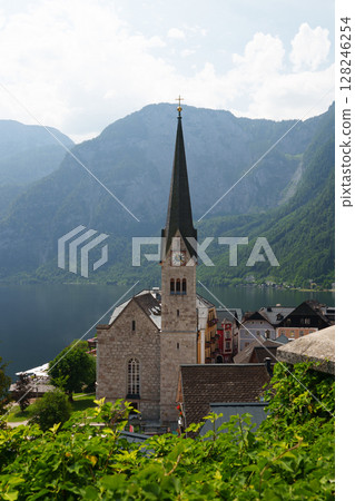 Church in Hallstatt against the backdrop of mountains and lake. Church in Hallstatt against the backdrop of mountains and lake. 128246254