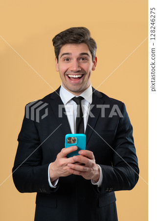 Happy surprised amazed businessman surfing internet on smartphone. Man using social networks 128246275