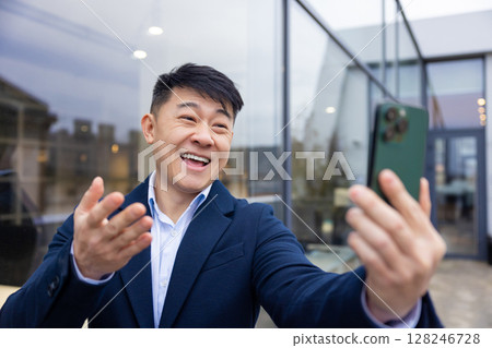 Young asian man in a suit with a phone in hand 128246728