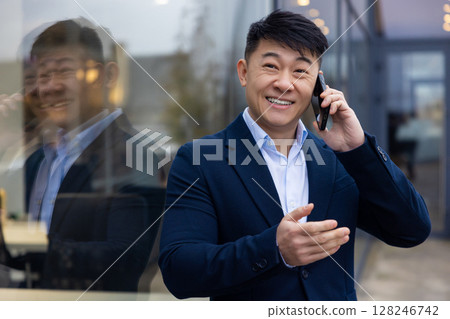 Young asian man in a suit with a phone in hand 128246742