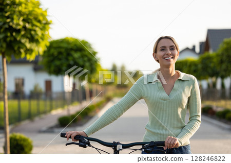 Lady with bicycle ready for outdoor ride in suburban setting Lady with bicycle ready for outdoor ride in suburban setting 128246822