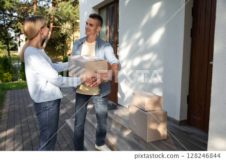 Two young people looking involved while packing for the moving to a new location 128246844