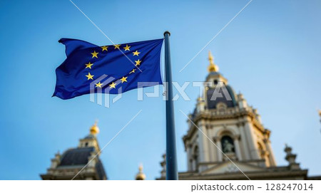 EU flag proudly waving against historic European architecture 128247014