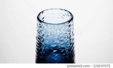 Textured ombre blue glass cup on white background 128247072