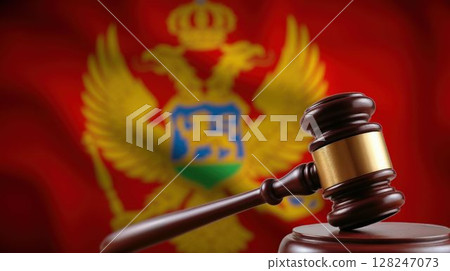 Close-up of judge's gavel with Montenegro flag behind 128247073