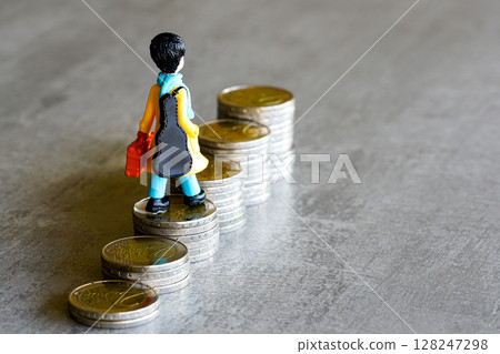Toy figure with guitar climbs stacked euro coins, symbolize journey toward financial, creative goals 128247298