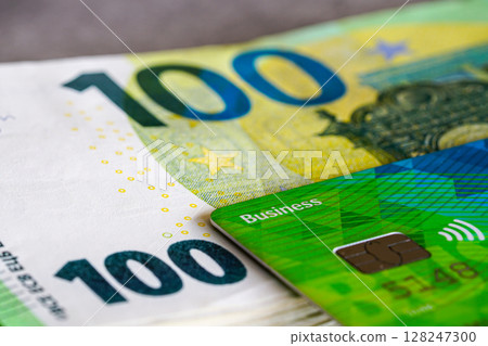 Close-up of business credit card on a 100 euro bill, symbolizing modern finance and payment methods 128247300