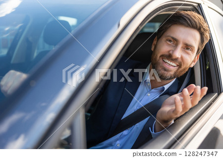 Confident young businessman in a car looking resolute and contented 128247347