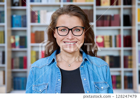 Headshot portrait smiling mature woman teacher in classroom 128247479