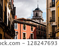 Charming architecture in Madrid, with a view of historic buildings and a church tower. 128247693