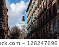 Charming architecture and blue skies define a picturesque street scene in Madrid, Spain. 128247696