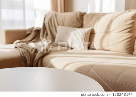 Empty white coffee table in a cozy living room with a beige couch. 128248144
