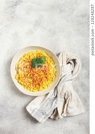 risotto with shrimp, in a bowl, on a textured surface, with a side dish of fresh coriander, homemade, no people, risotto with shrimp, in a bowl, on a textured surface, with a side dish of fresh coriander, homemade, no people, 128248287