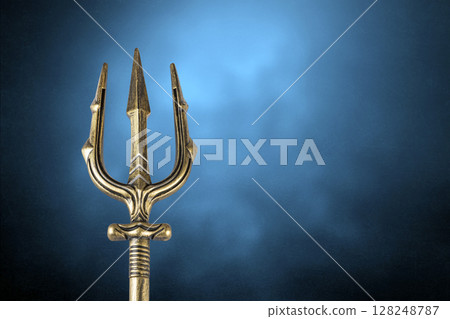 Golden trident over blue misty background Golden trident over blue misty background 128248787