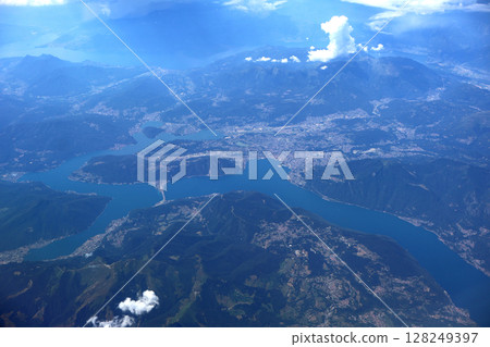 Aerial View of Stunning Lake Surrounded by Mountains and Villages in Sunny Weather Aerial View of Stunning Lake Surrounded by Mountains and Villages in Sunny Weather 128249397