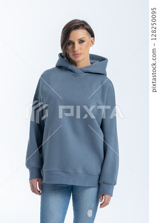Portrait beautiful woman of model appearance. Girl in grey sweatshirt on grey background. Pretty female with trendy makeup posing in studio. Vertical photo. High quality photo Portrait beautiful woman of model appearance. Girl in grey sweatshirt on grey background. Pretty female with trendy makeup posing in studio. Vertical photo. High quality photo 128250095