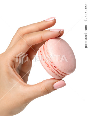 Hand holding delicate pink macaron, french pastry, isolated on transparent background, sweet dessert, gourmet treat, bakery item 128250368