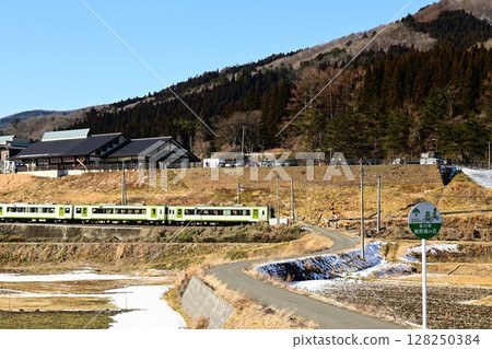 Roadside station Tono Kaze no Oka and the Kamaishi Line as seen from the rice paddy fields of Tono 128250384