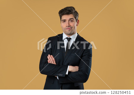 Confident arrogant businessman posing with smug expression and crossed arms Confident arrogant businessman posing with smug expression and crossed arms 128250451