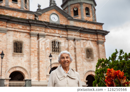 Senior woman at the beautiful colonial town of Concepcion located in the department of Antioquia in Colombia. Church of Our Lady of the Immaculate Conception. 128250566