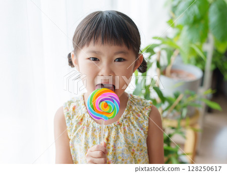 Child eating candy 128250617
