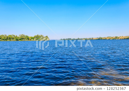 Summer landscape with beautiful river, green trees and blue sky 128252367