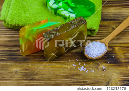 Set of handmade soap bars, sea salt and towel on wooden background. SPA concept 128252376