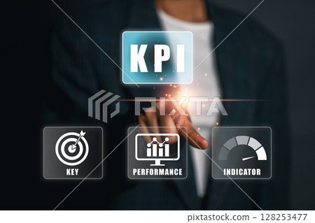 Businessman interacting with KPI interface, highlighting key performance indicators for business success. 128253477