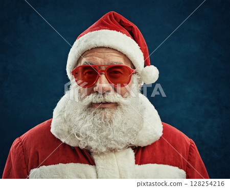 Portrait of stylish Santa Claus on blue background.  128254216
