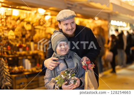 Dad and son at the fair in winter 128254663