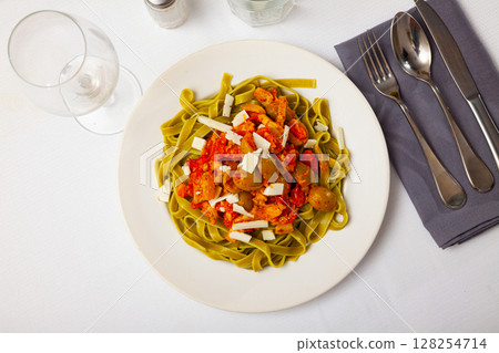 Spinach pasta with olives, cheese and gravy Spinach pasta with olives, cheese and gravy 128254714