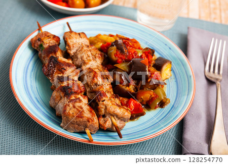 Grilled pork meat shashlik with sauteed vegetables 128254770