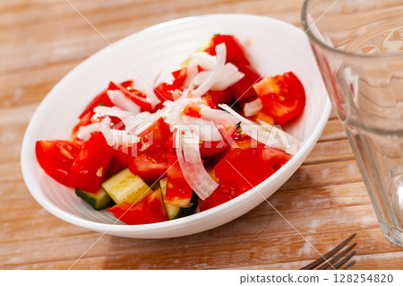 Vegetarian salad with tomatoes, cucumbers and onion Vegetarian salad with tomatoes, cucumbers and onion 128254820