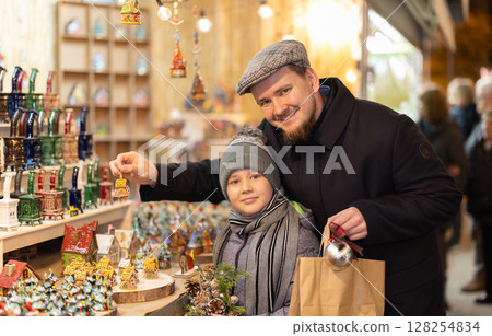 Man and son choosing Christmas decorations Man and son choosing Christmas decorations 128254834