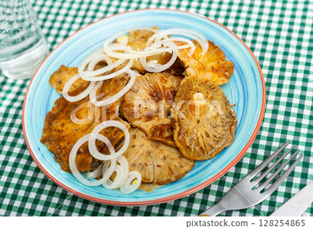 Salad of pickled wild mushrooms and sliced onion on plate Salad of pickled wild mushrooms and sliced onion on plate 128254865